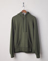 Front view of vine green organic heavyweight cotton #7004 jersey hooded sweater by Uskees presented on hanger.
