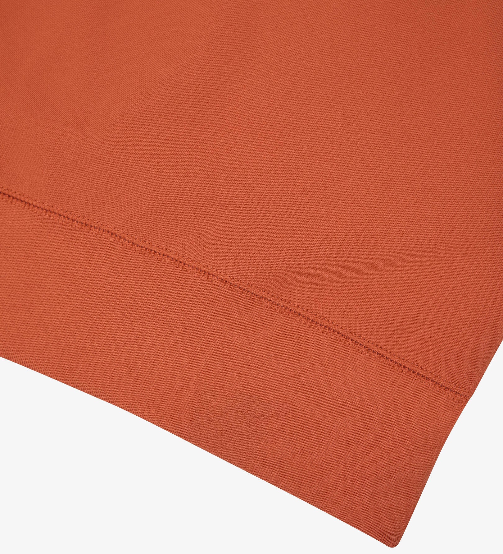 Closer view view of the ribbed hem of the Uskees cinnamon-orange organic heavyweight cotton 7005 jersey sweatshirt.