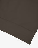 Closer view view of the ribbed hem of the Uskees dark taupe organic heavyweight cotton 7005 jersey sweatshirt.