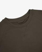 Close-up view of crew neck collar with decorative v-insert on Uskees dark taupe heavyweight cotton jersey sweatshirt.