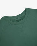 Close-up view of crew neck collar with decorative v-insert on Uskees green heavyweight cotton jersey sweatshirt.