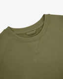 Close-up view of crew neck collar with decorative v-insert on Uskees herb-green heavyweight cotton jersey sweatshirt.