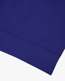 Closer view view of the discreet brand logo on ribbed hem of the Uskees vibrant blue organic heavyweight cotton 7005 jersey sweatshirt.