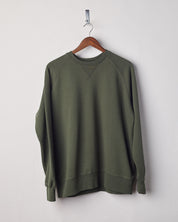 Front view of vine green organic heavyweight cotton #7005 jersey sweatshirt by Uskees presented on hanger.