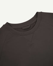 Close up shot of Uskees 7005 crew neck sweatshirt in faded black