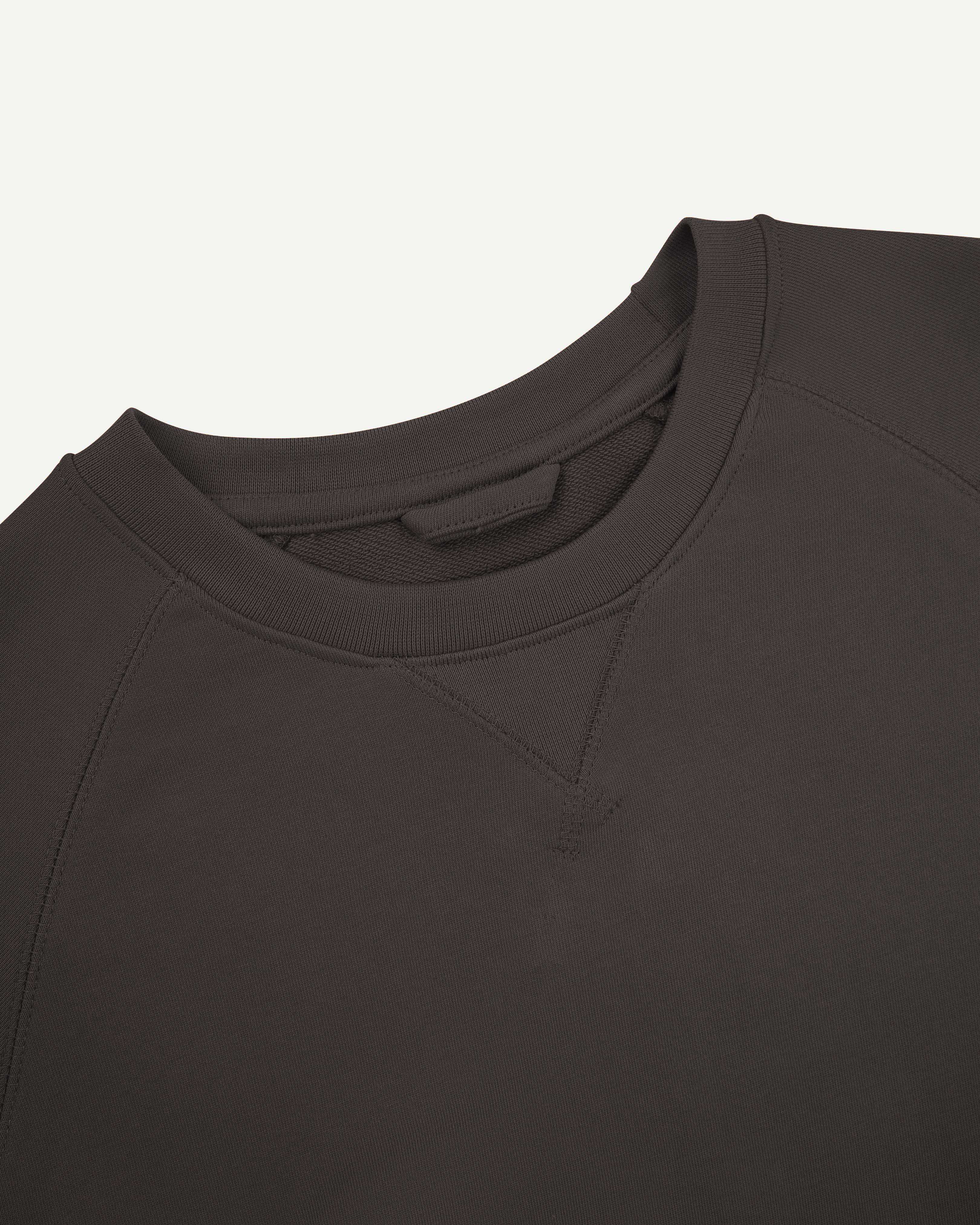 Close up shot of Uskees 7005 crew neck sweatshirt in faded black