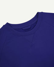 Close up neckline view of ultra-blue organic heavyweight cotton 7005 sweatshirt by Uskees showing crew neck and decorative v-insert