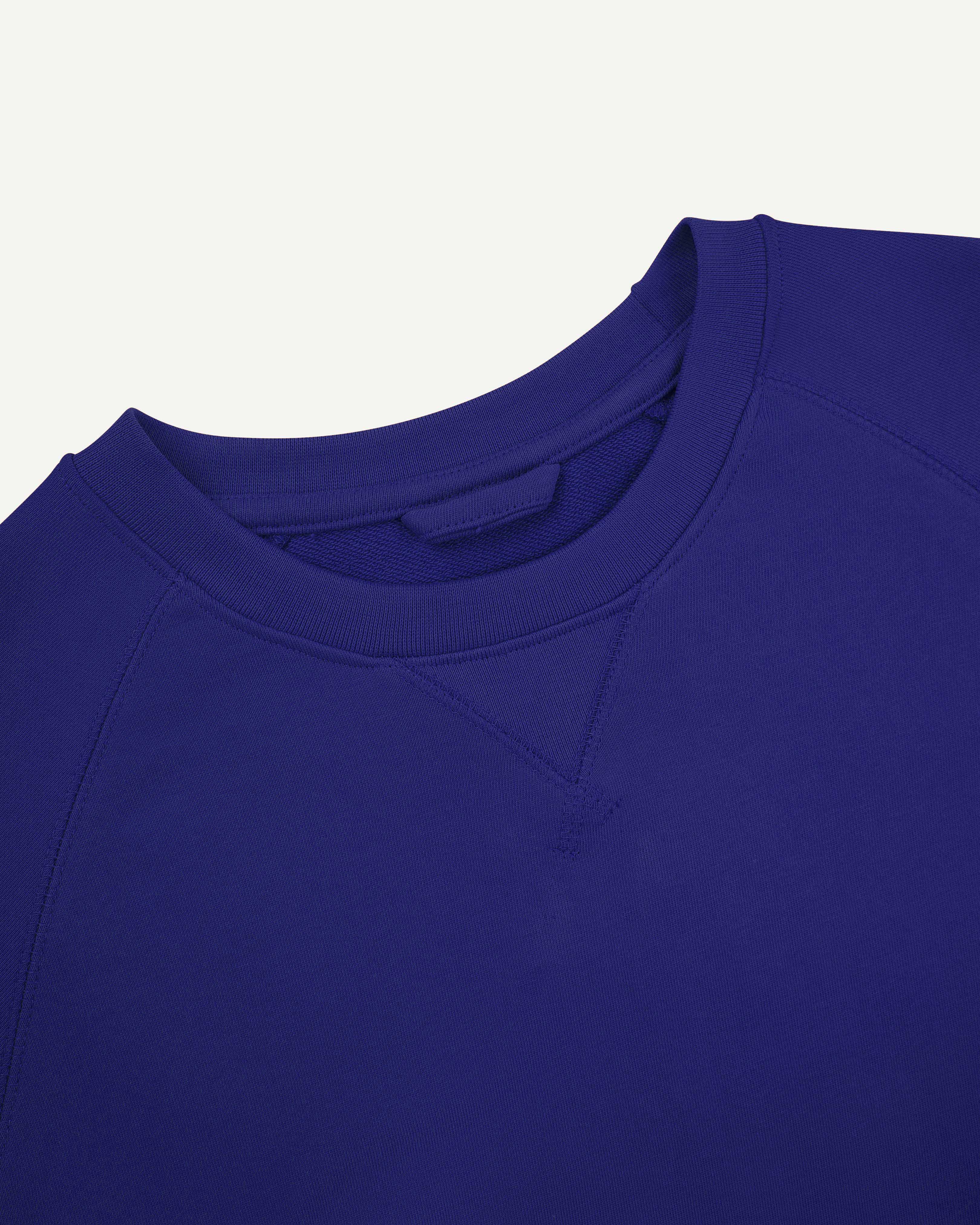 Close up neckline view of ultra-blue organic heavyweight cotton 7005 sweatshirt by Uskees showing crew neck and decorative v-insert