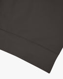 Close up shot of hem on Uskees 7005 crew neck sweatshirt in faded black