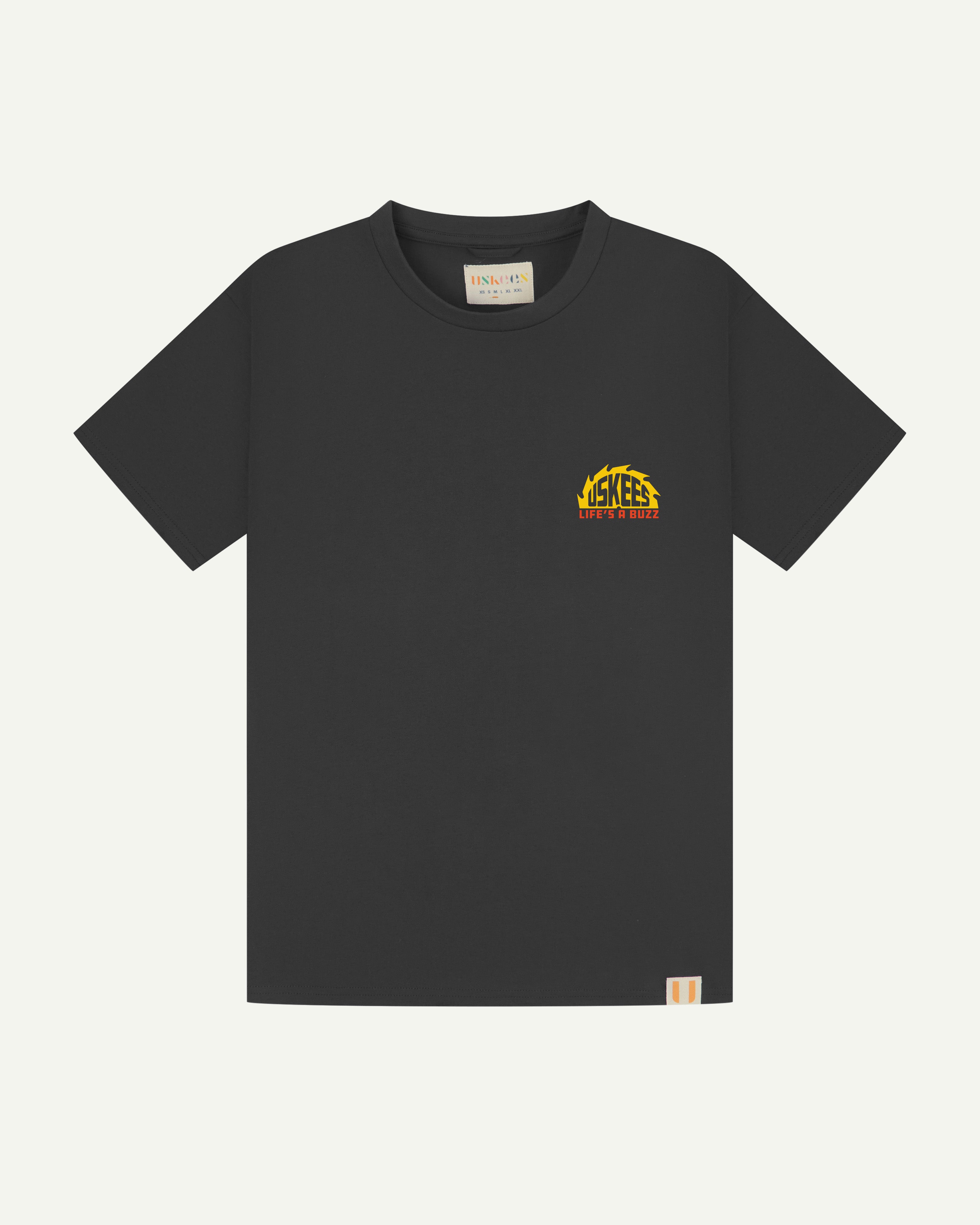 Flat shot of uskees graphic 'life's a buzz' short sleeve Tee for men showing the small graphic logo.