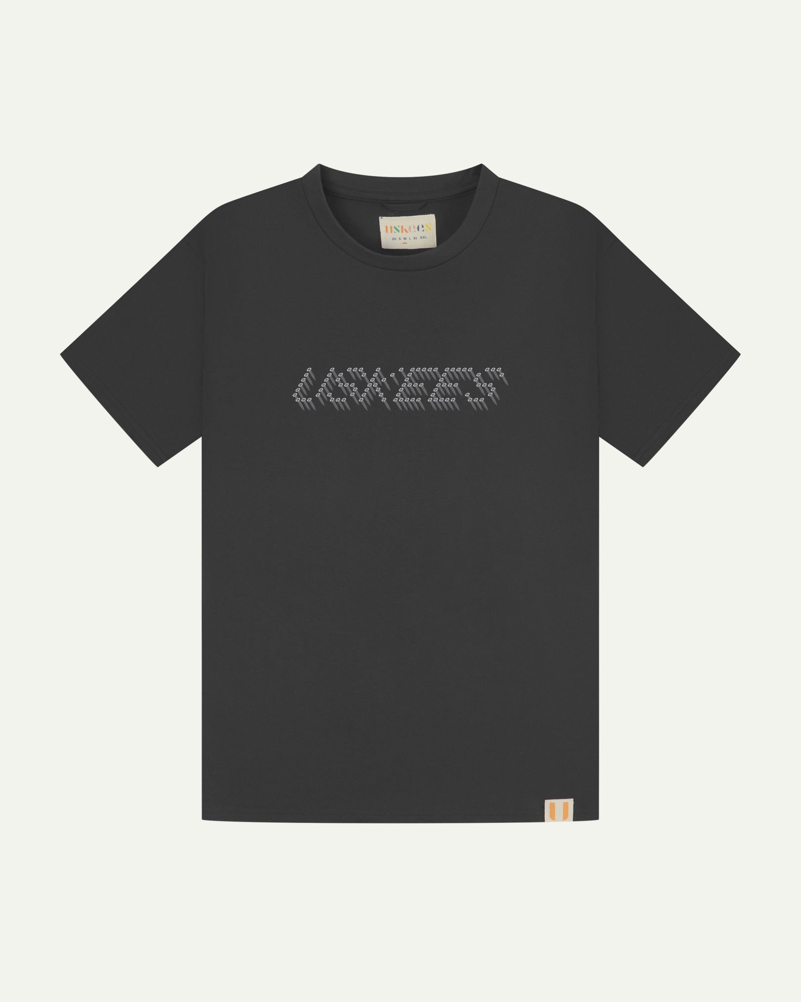 Front flat view of Uskees men's graphic t-shirt in black showing the philips head screw graphic on the chest and the branding labels on the neck and hem.