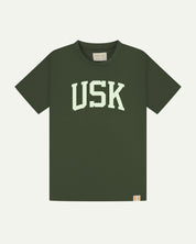Full flat view of coriander-green organic cotton signature T-shirt for men, showing the varsity inspired 'USK' logo on the chest and the Uskees branding labels on the neck and hem.