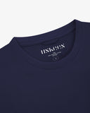 Close up shot of Uskees dark blue t-shirt for men on a white background showing the neck branding and size.