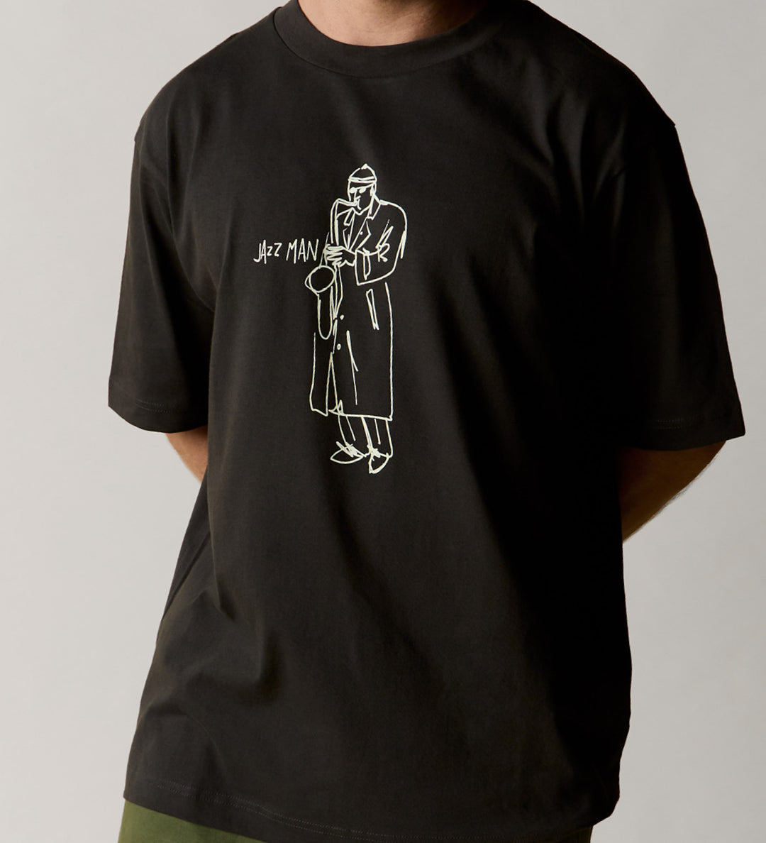 Front view wearing the oversized uskees men's 'Jazz Man' tee in black demonstrating the loose, relaxed fit.