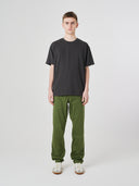 Full-length view of model wearing 7006 faded black organic cotton t-shirt, demonstrating loose fit.