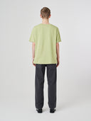 Back view of model wearing 7006 green-yellow organic cotton t-shirt.