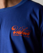 Wearing the uskees ultra blue men's 'diner' tee with a focus on the small bright orange 'diner' logo on the chest.