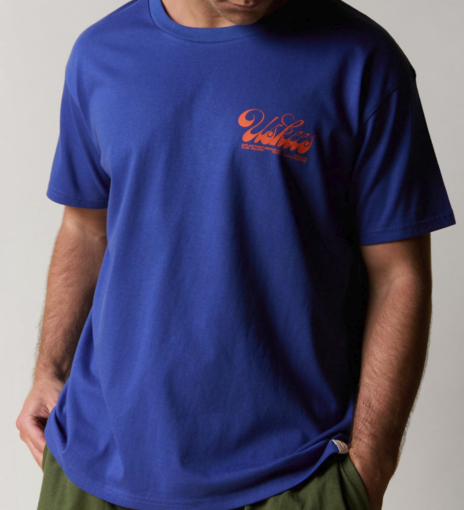 Front view wearing the uskees men's 'diner' tee in ultra blue demonstrating the loose, relaxed fit.