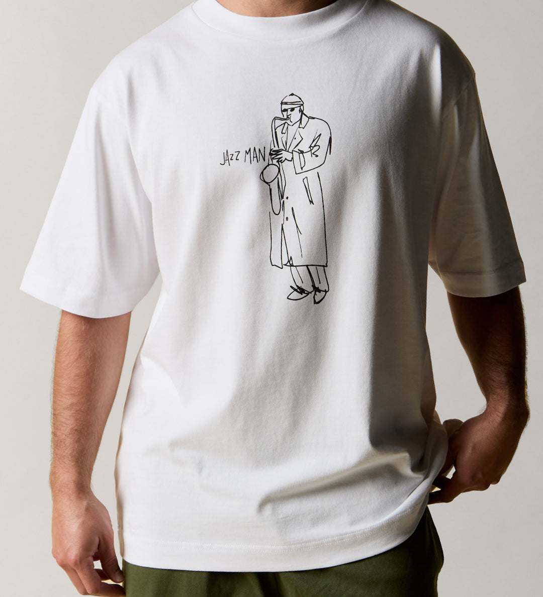 Front view wearing the oversized uskees men's 'Jazz Man' tee in white, demonstrating the loose, relaxed fit.