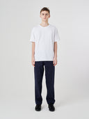 Full-length view of model wearing 7006 white organic cotton t-shirt, demonstrating loose fit.