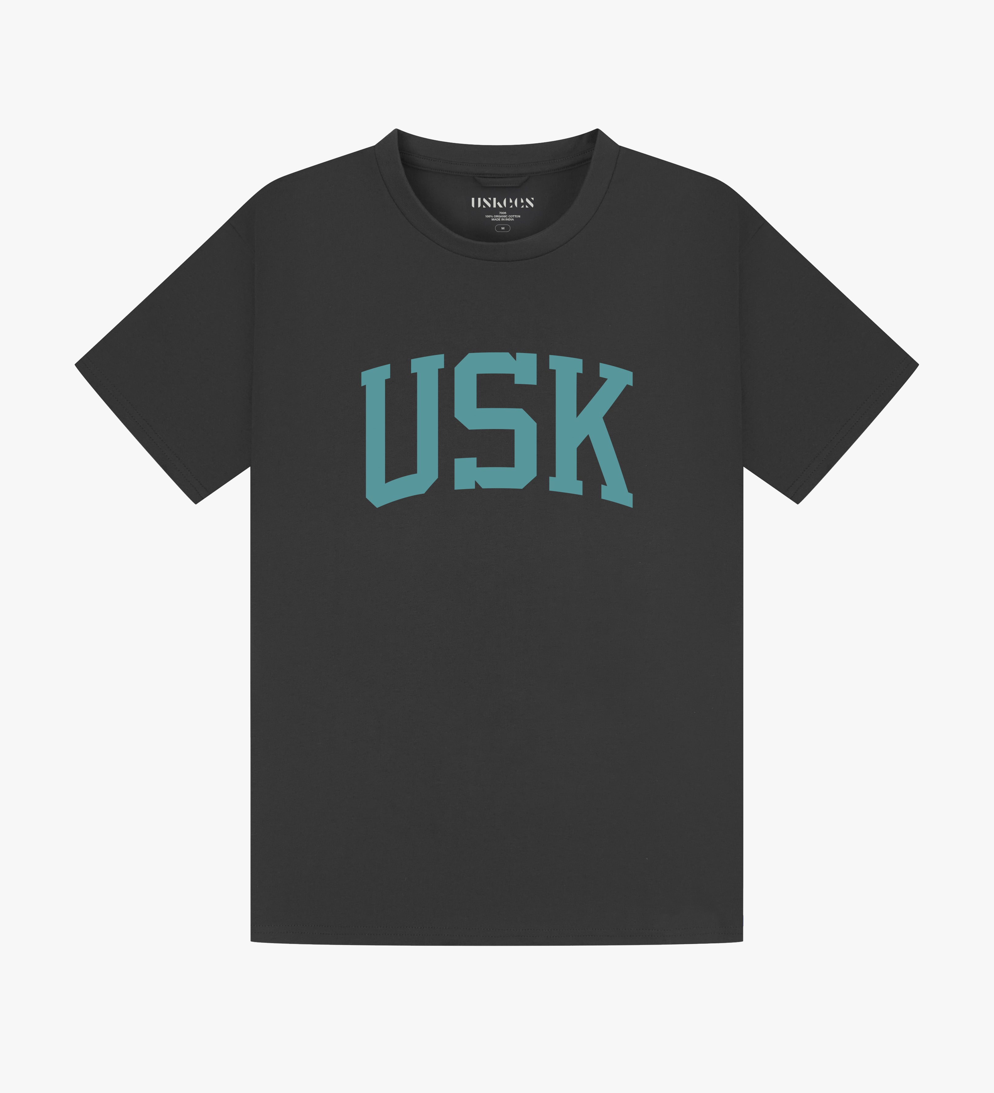 Full flat view of faded black organic cotton signature T-shirt for men, showing the varsity inspired 'USK' logo on the chest and the Uskees branding labels on the neck and hem.