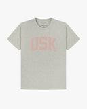 Full flat view of grey marl organic cotton signature T-shirt for men, showing the varsity inspired 'USK' logo on the chest and the Uskees branding labels on the neck and hem.