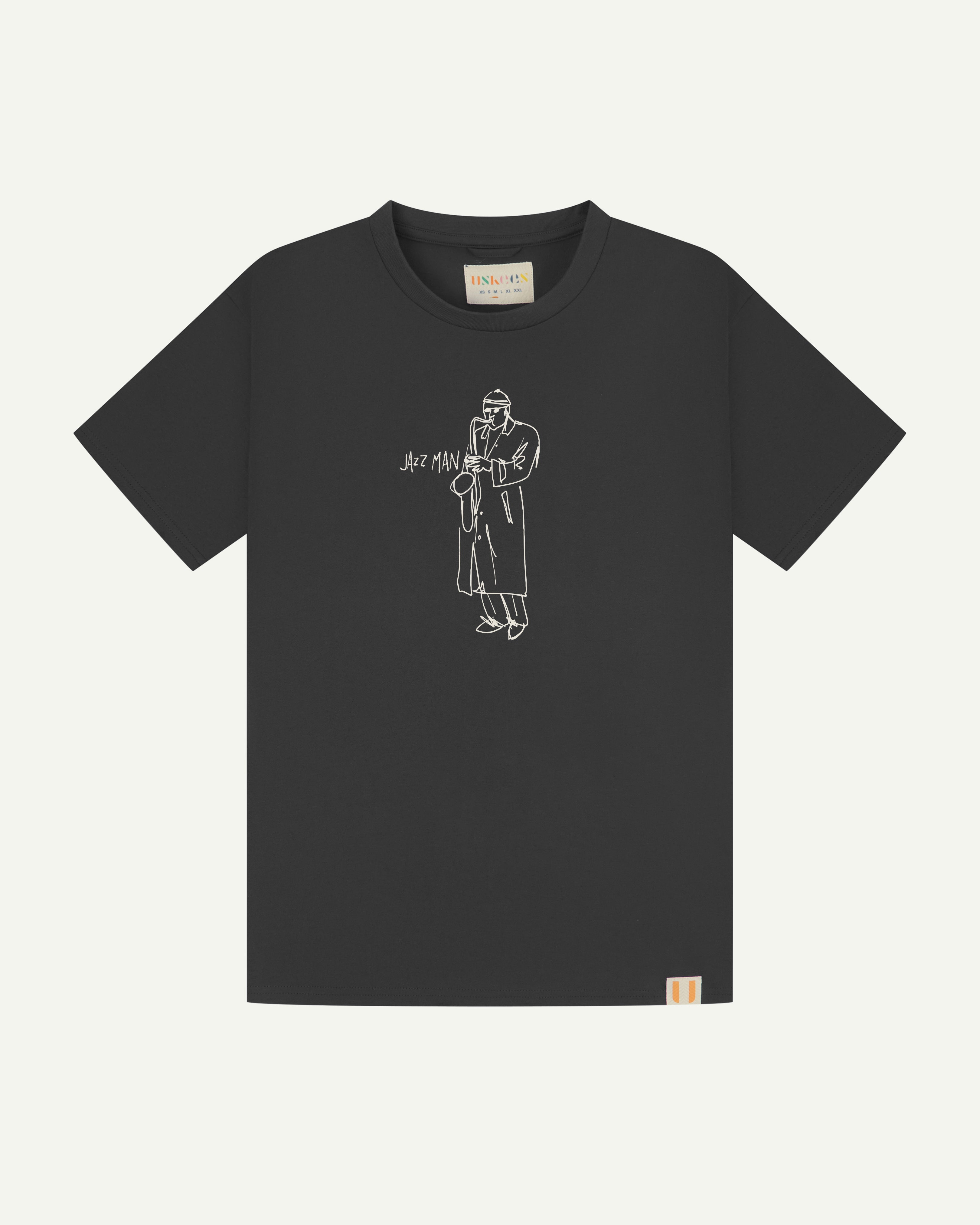front flat shot of uskees men's short sleeve  graphic Tee in faded black with the 'jazz man' line drawing on the front in white