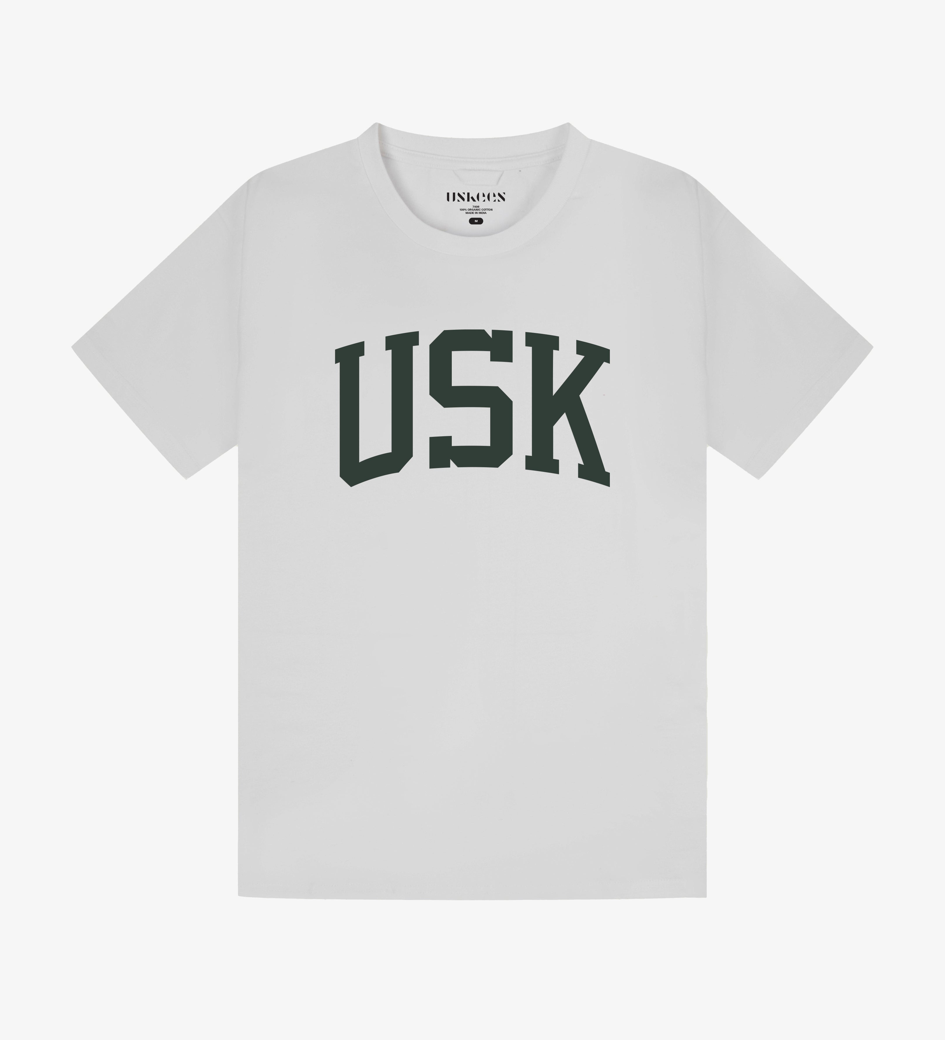 Full flat view of white organic cotton signature T-shirt for men, showing the varsity inspired 'USK' logo on the chest and the Uskees branding labels on the neck and hem.