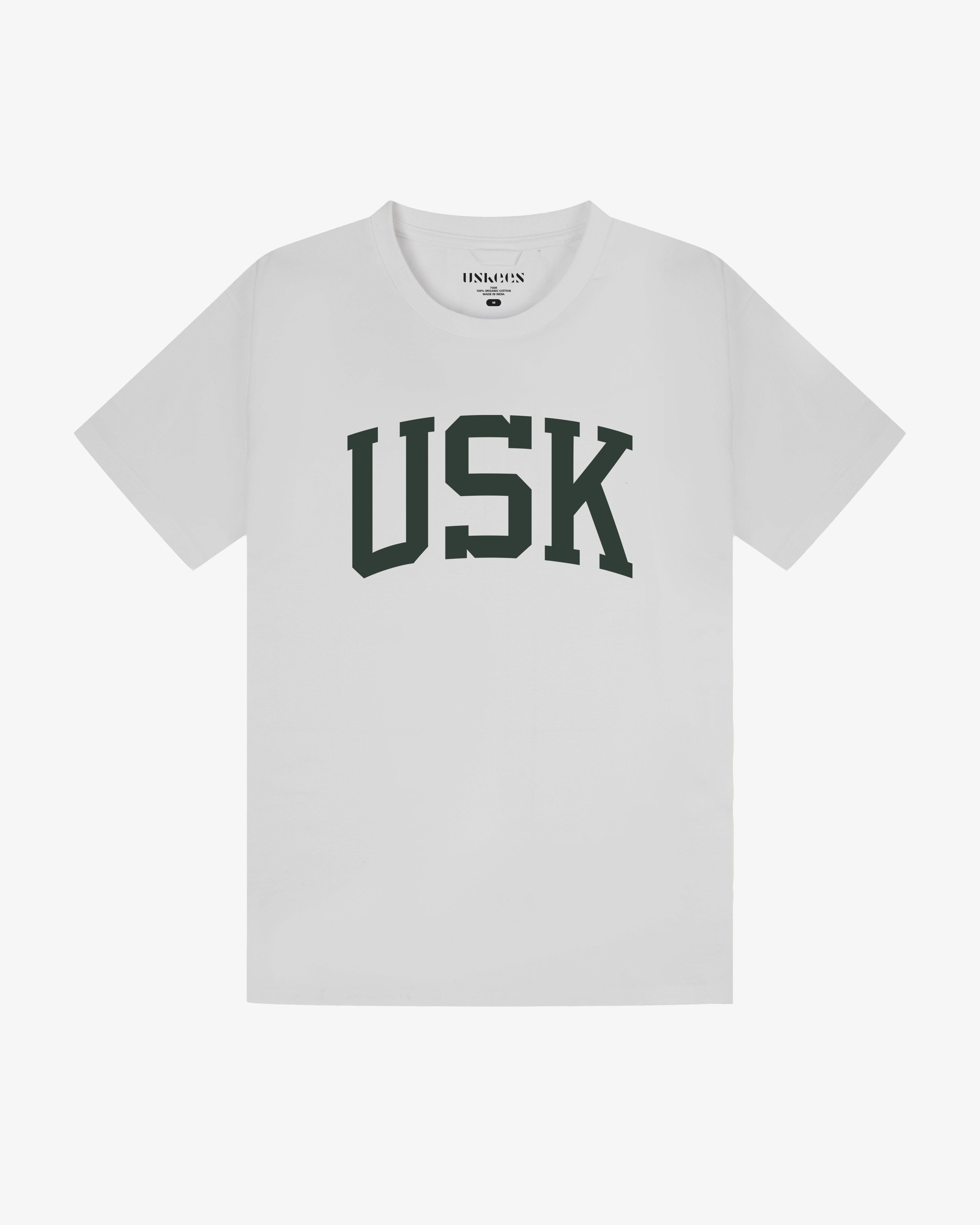 Full flat view of white organic cotton signature T-shirt for men, showing the varsity inspired 'USK' logo on the chest and the Uskees branding labels on the neck and hem.