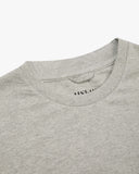 Neckline close-up of Uskees grey marl organic cotton T-shirt showing hanging loop and branding stamp.