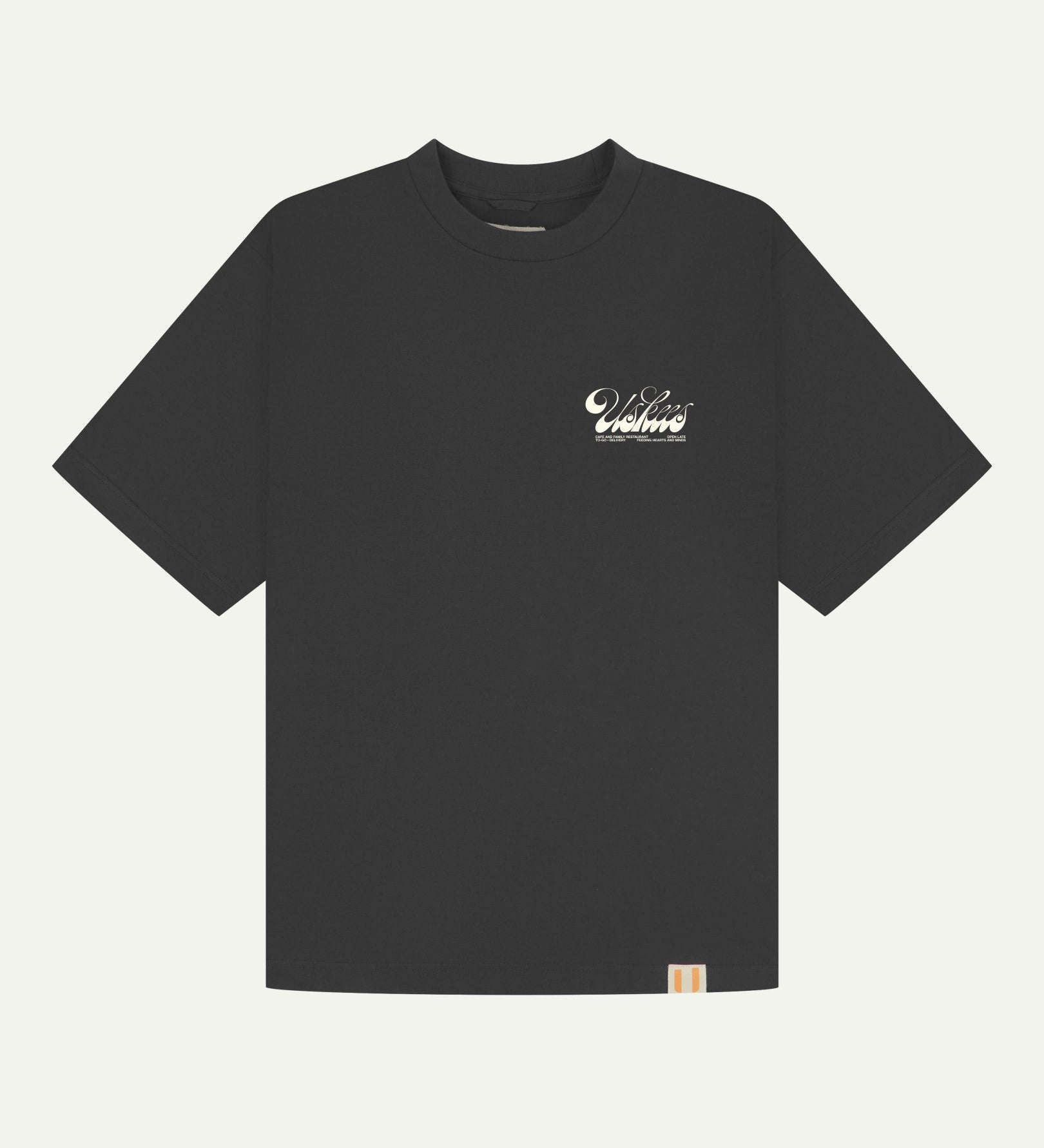 Full flat view of oversized black organic cotton Uskees T-shirt for men, showing the small white 'diner' logo on the breast.