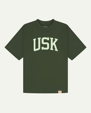 Full flat view of oversized coriander-green organic cotton signature T-shirt for men, showing the varsity inspired 'USK' logo on the chest and the Uskees branding labels on the neck and hem.