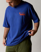 Front view wearing the uskees men's 'diner' tee in ultra blue demonstrating the loose, oversized fit.