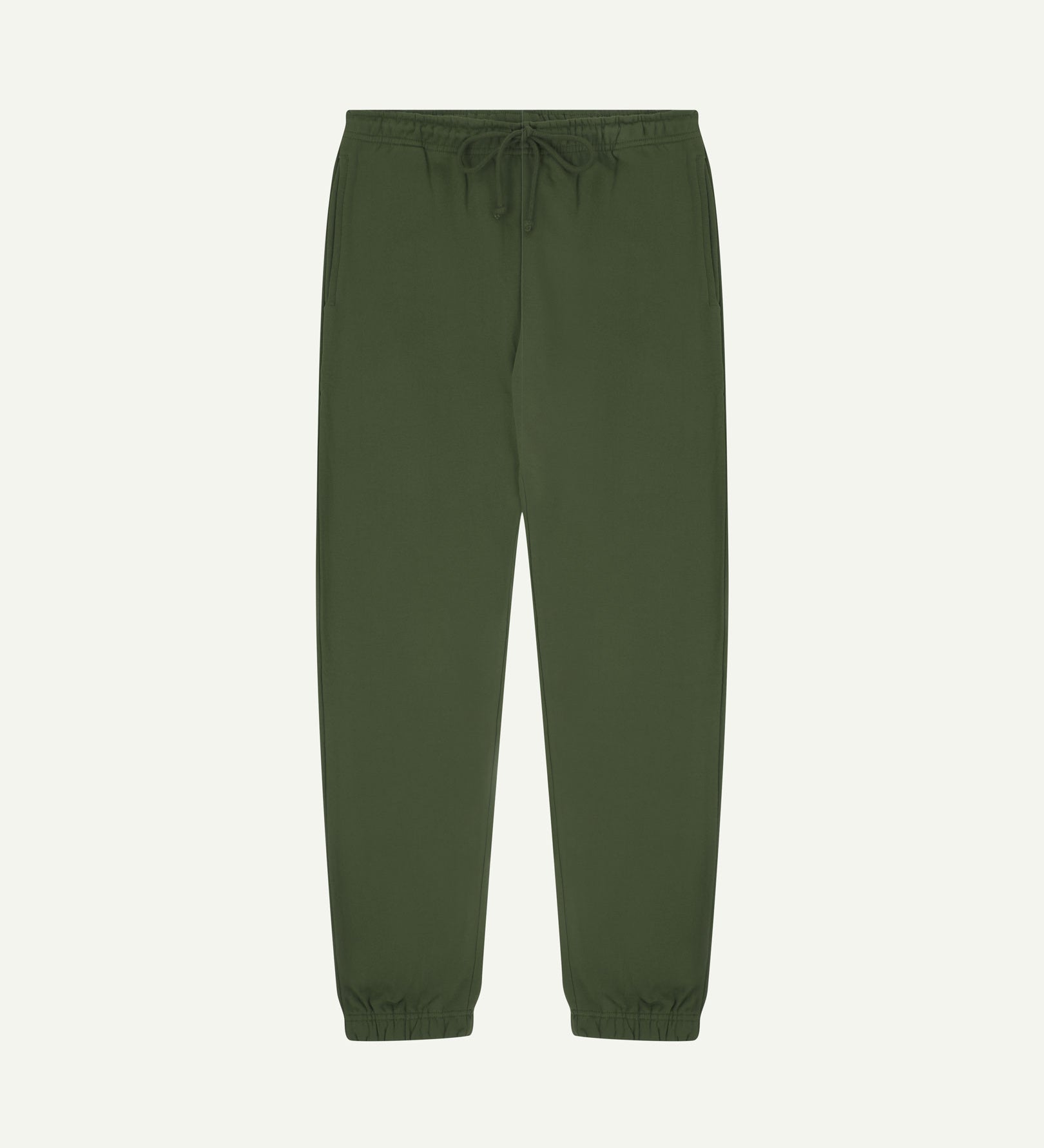 Front view of Uskees jogging pants in mid-green organic cotton.