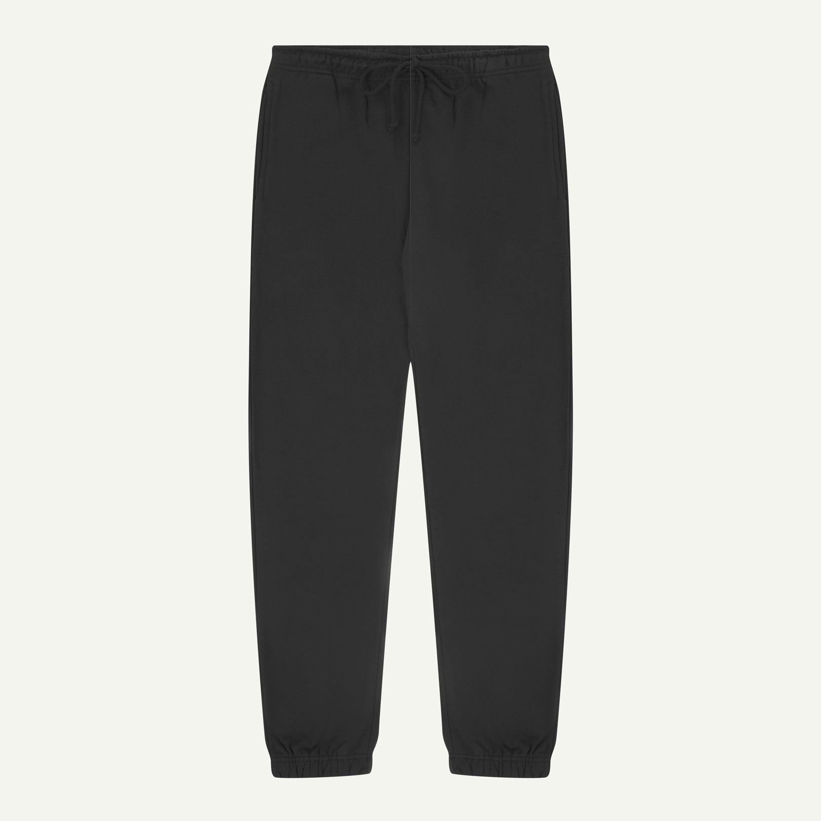 Front view of Uskees jogging pants in faded black organic cotton.