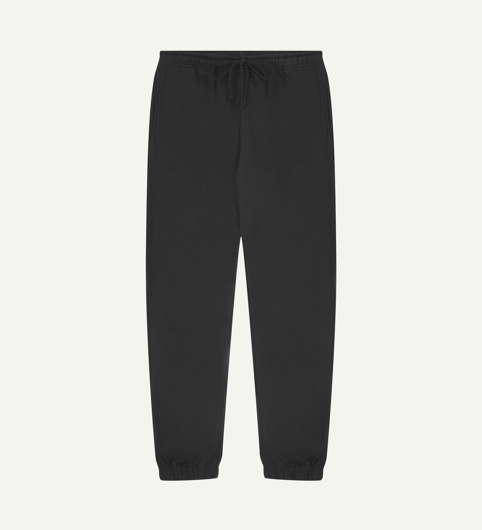 Front view of Uskees jogging pants in faded black organic cotton.