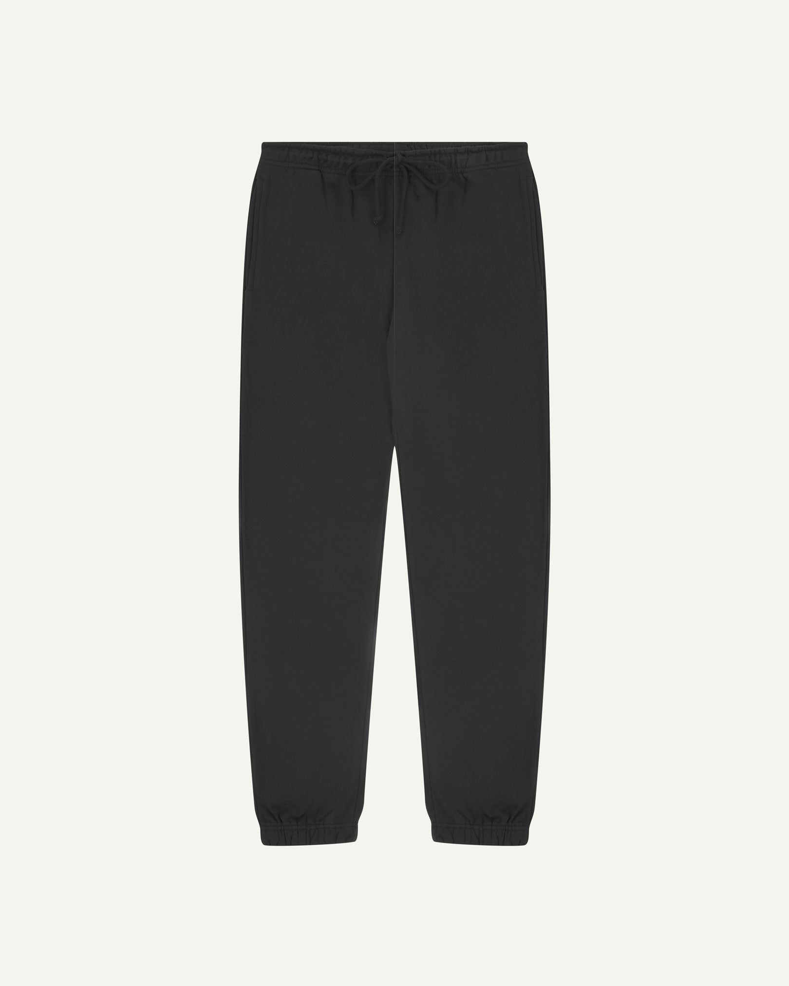 Front view of Uskees jogging pants in faded black organic cotton.