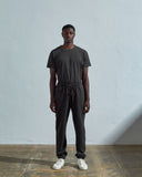 Full-length front view of model wearing #7009 faded black medium weight basic jogging pants from Uskees.
