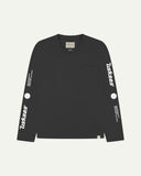 Front flat view of Uskees men's long-sleeve graphic t-shirt in black showing 'Uskees Power Tools' slogans and graphics on each arm and branding label on neck.