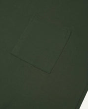 Sleeve and neckline close-up of Uskees coriander-green organic cotton long-sleeved T-shirt with focus on breast pocket.