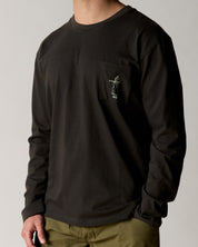 Front view wearing the uskees men's 'jazz man' long-sleeve tee in faded black demonstrating the loose, relaxed fit and highlighting the white 'Jazz Man' logo on the breast pocket.