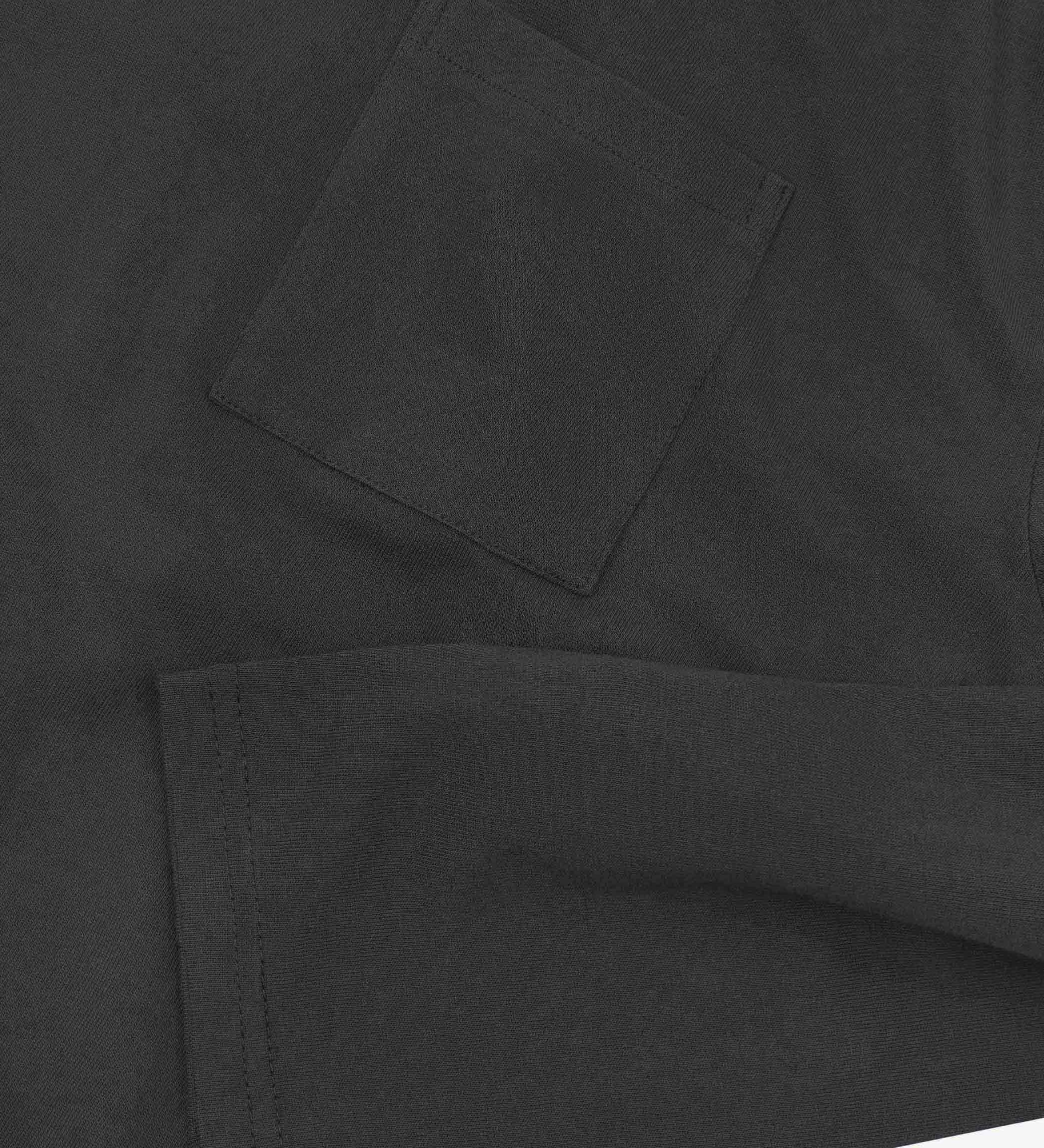 Closer look at the chest pocket and cuff of the faded black organic cotton long sleeve T-shirt showing texture of the medium weight organic cotton jersey.