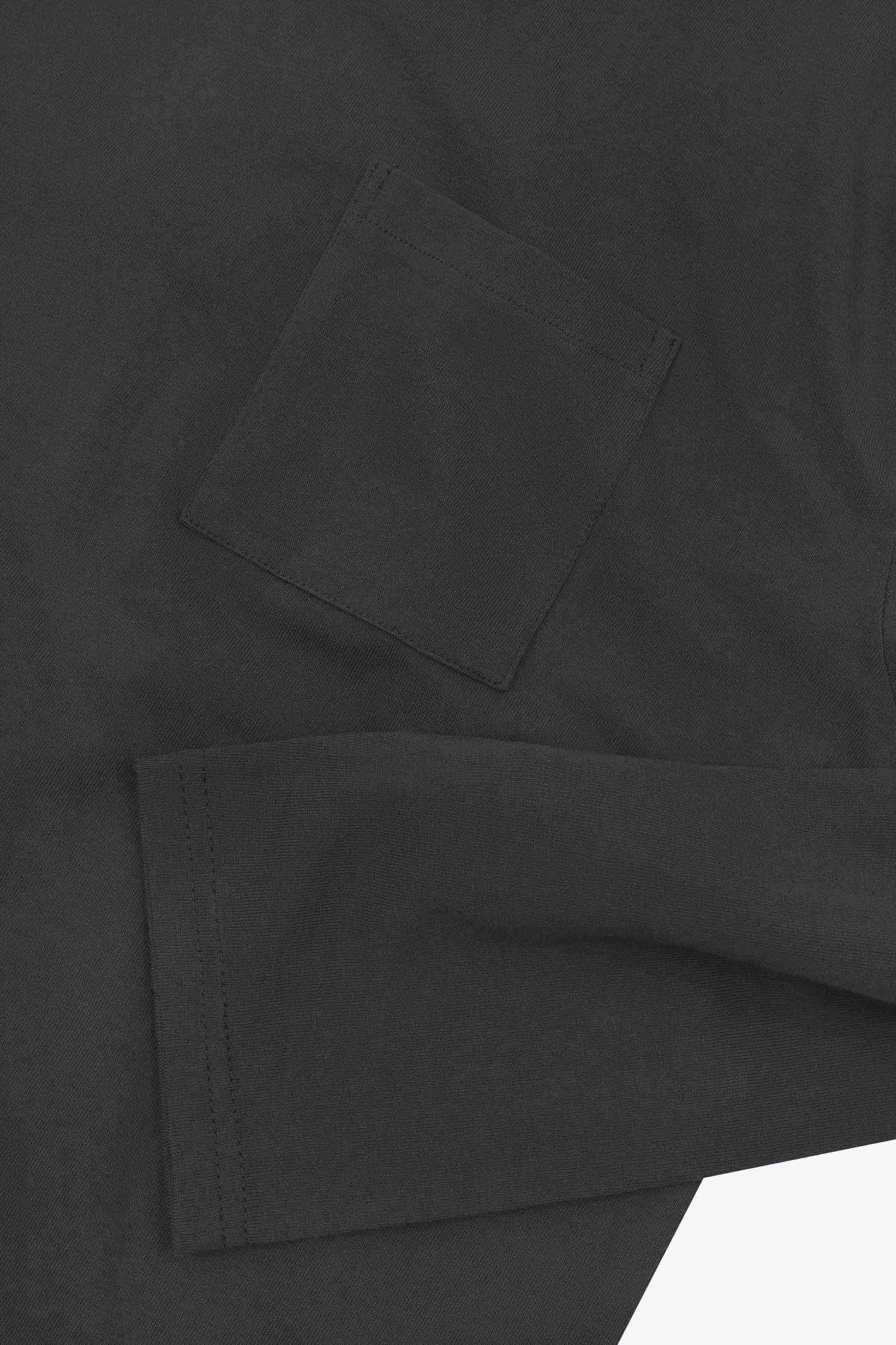 Closer look at the chest pocket and cuff of the faded black organic cotton long sleeve T-shirt showing texture of the medium weight organic cotton jersey.