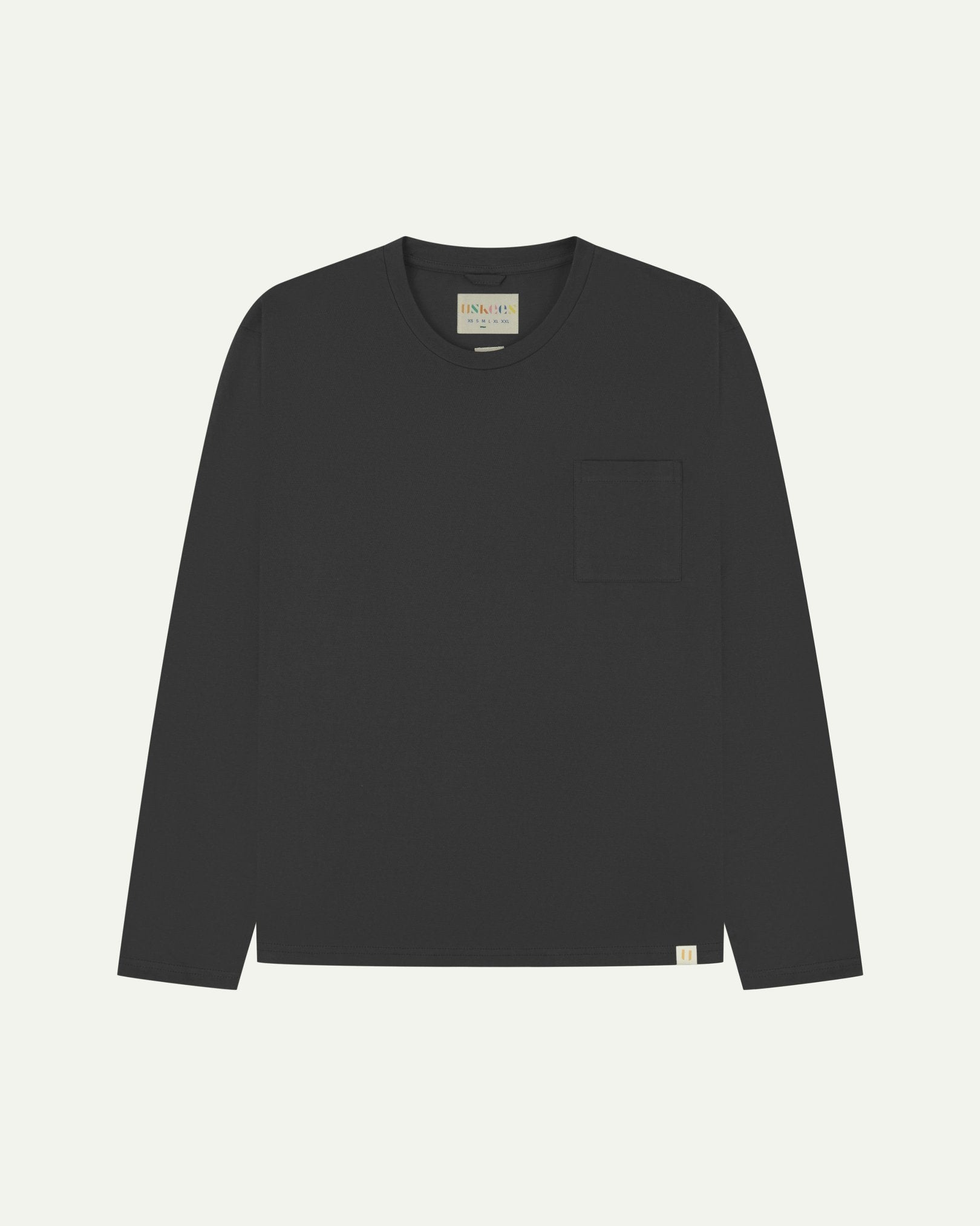 Full flat view of the Uskees faded black organic cotton long-sleeve T-shirt for men, showing the loose silhouette.