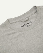 Neckline close-up of Uskees grey marl organic cotton long-sleeve T-shirt showing hanging loop and branding stamp.