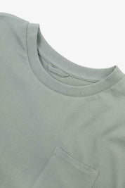 Neckline close-up of Uskees grey-green 'steel' coloured organic cotton long-sleeve T-shirt showing hanging loop and pocket.