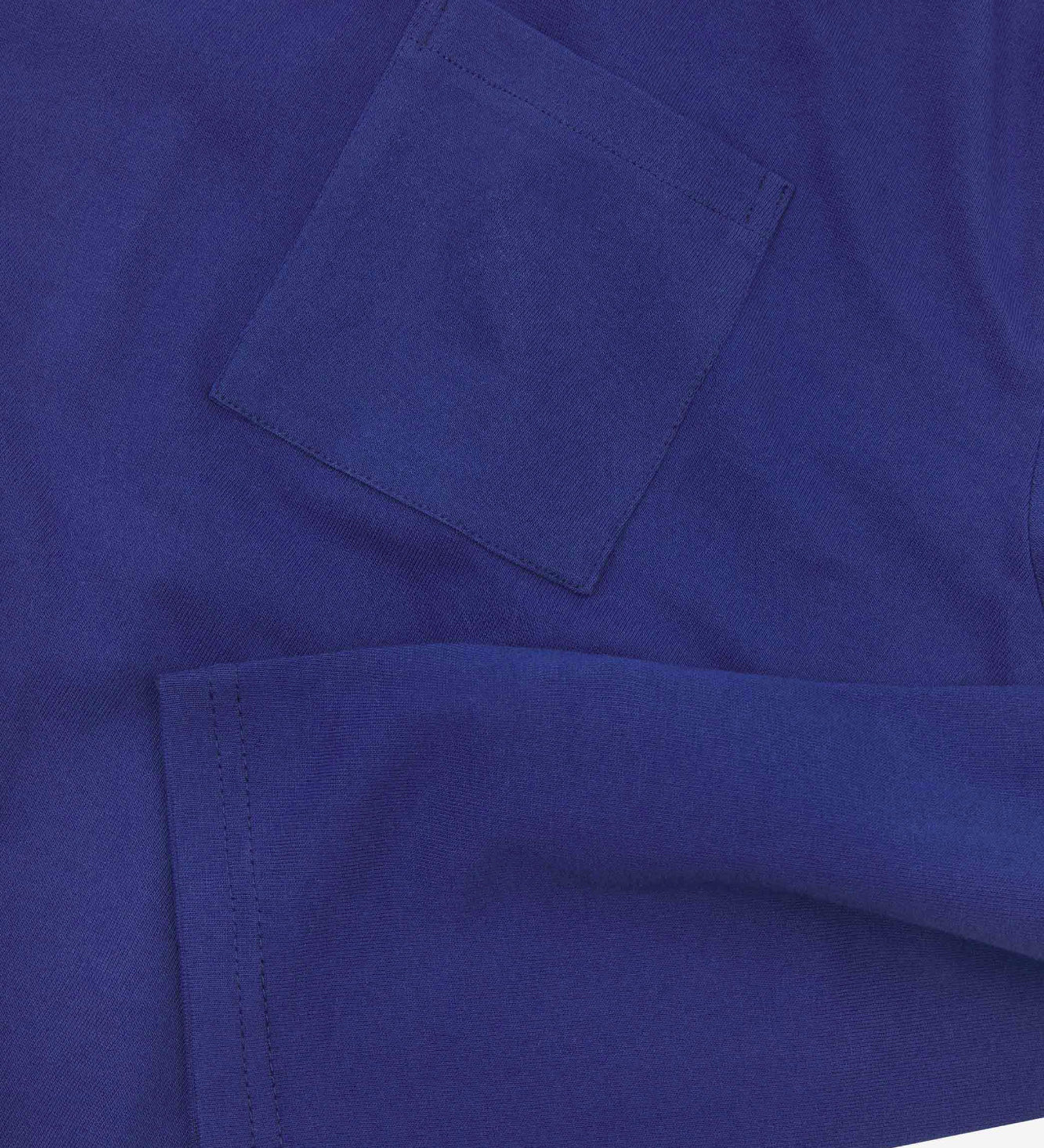 Closer look at the chest pocket and cuff of the ultra blue organic cotton long sleeve T-shirt showing texture of the medium weight organic cotton jersey.