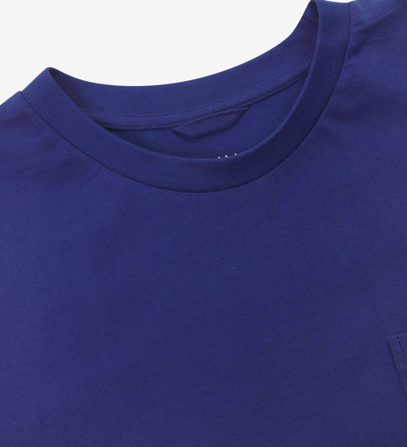 Neckline close-up of Uskees ultra blue organic cotton long-sleeve T-shirt showing hanging loop and branding stamp.