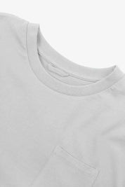 Neckline close-up of Uskees white organic cotton long-sleeve T-shirt showing hanging loop and pocket.