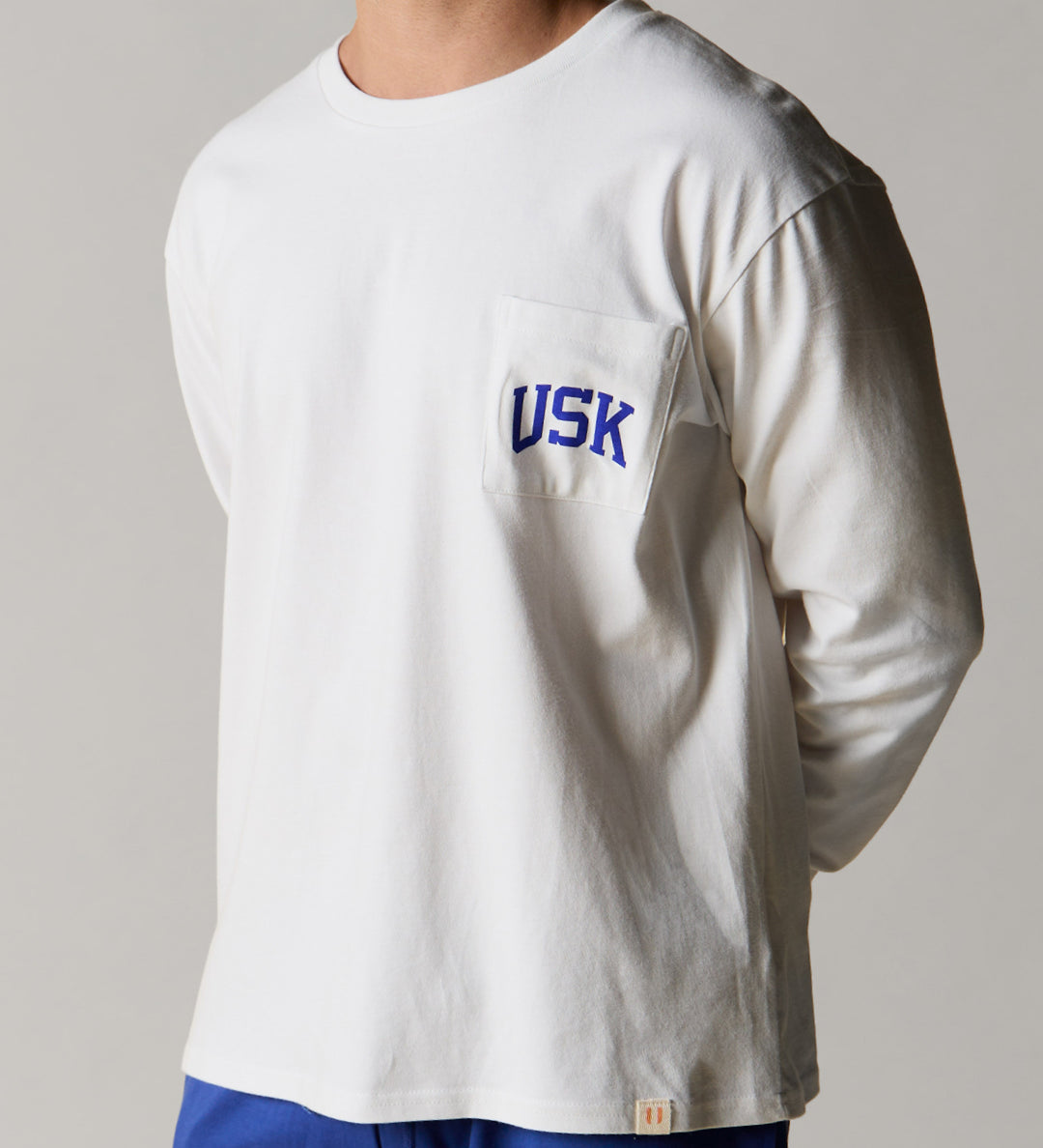 Front view wearing the white organic cotton signature long sleeve T-shirt for men, demonstrating the loose, relaxed fit.